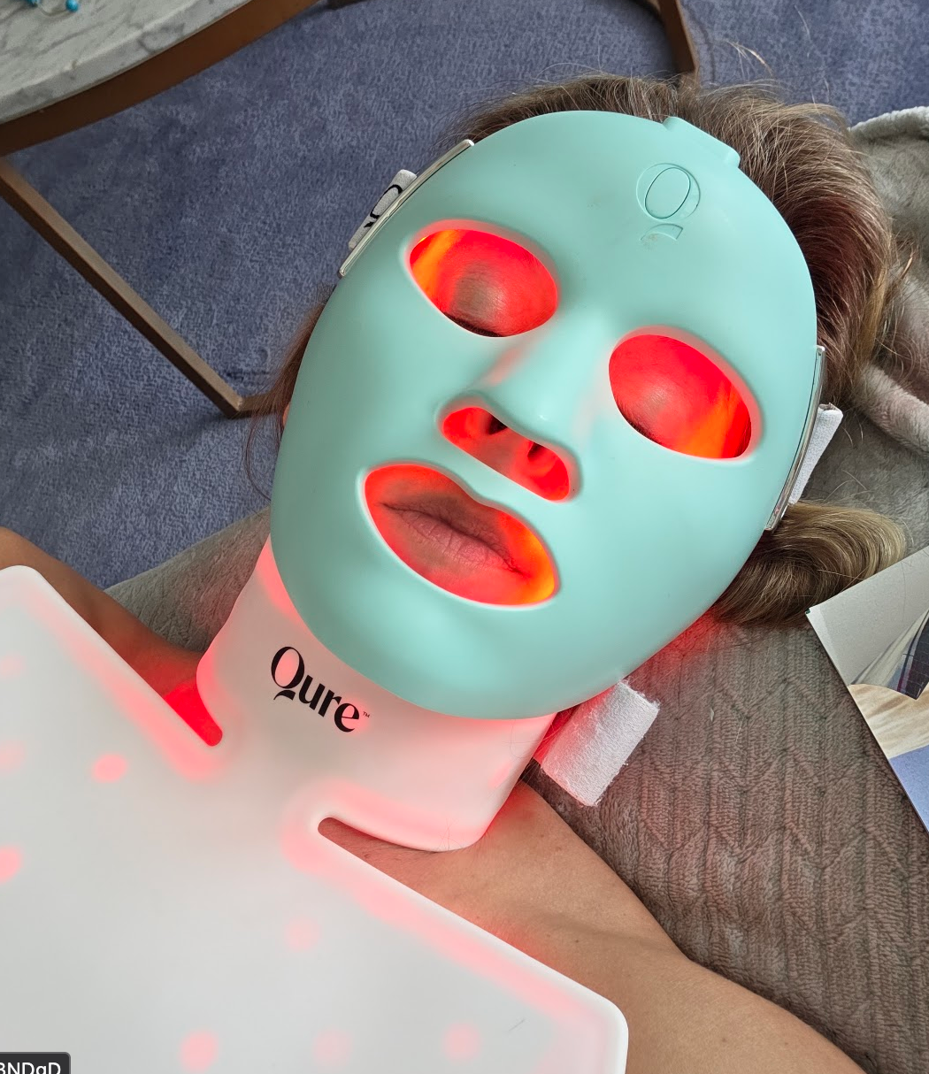 Qure LED red light face and neck mask in use